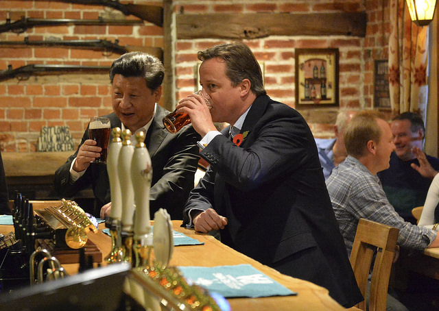 Chinese President Xi Jinping and British Prime Minister drink a toast to increased Sino-U.K. trade.